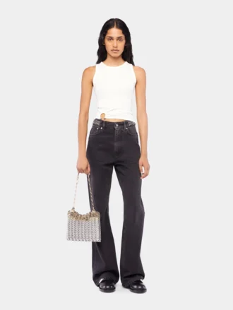 Kenmerkende zwarte jeans met schijfjes uit 1969